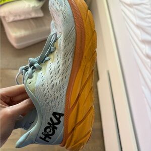 HOKA Women's Pale Blue Running Shoe with Orange Sole